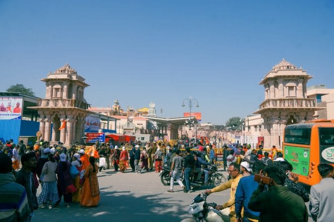 a crowd of people standing around a street